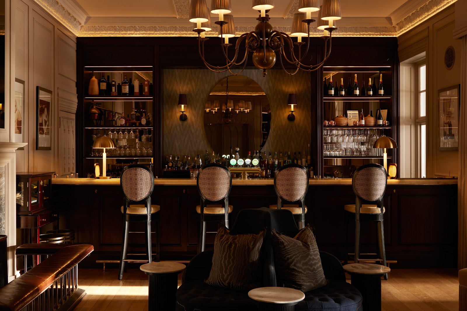 A champagne coupe and cocktail on a dark onyx bar at Planet Bar in the Mount Nelson Cape Town