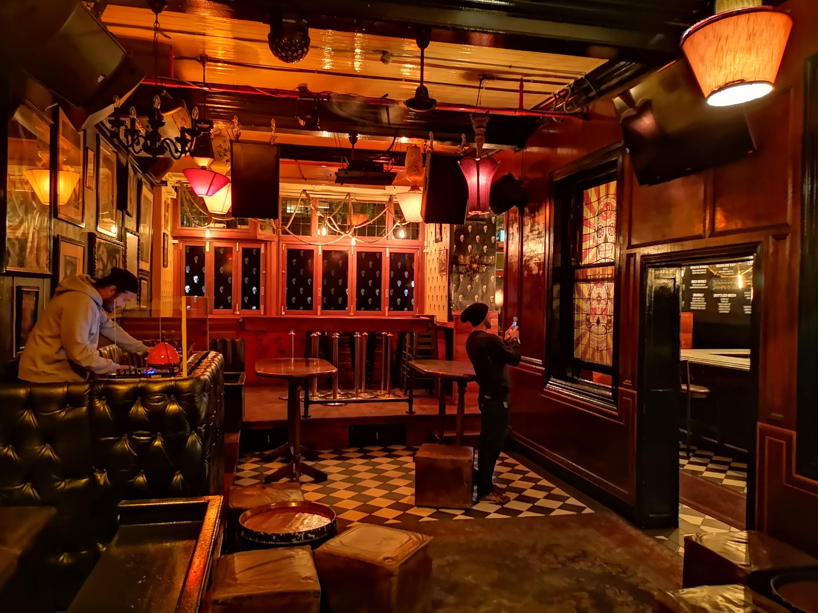Dark rock bar interior with posters and low light