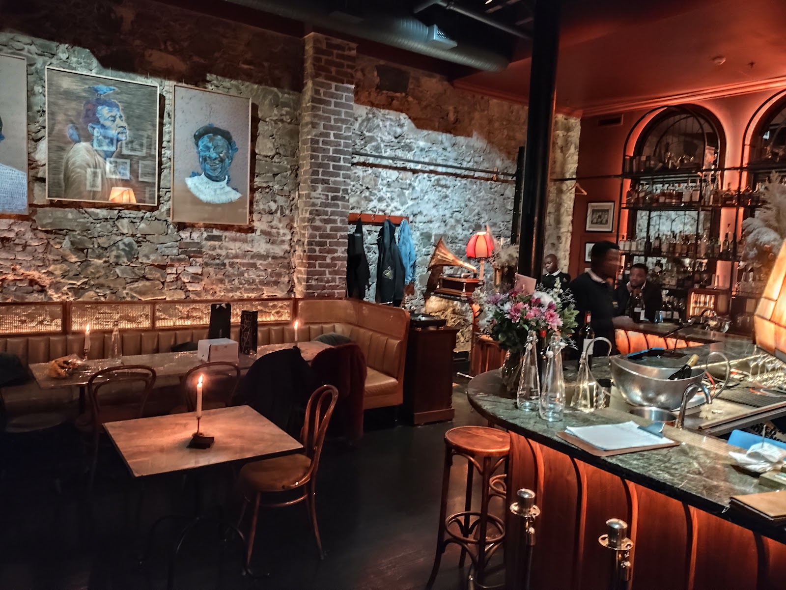 Dim speakeasy interior with leather seating, similar in mood to The Athletic Club and Social in Cape Town