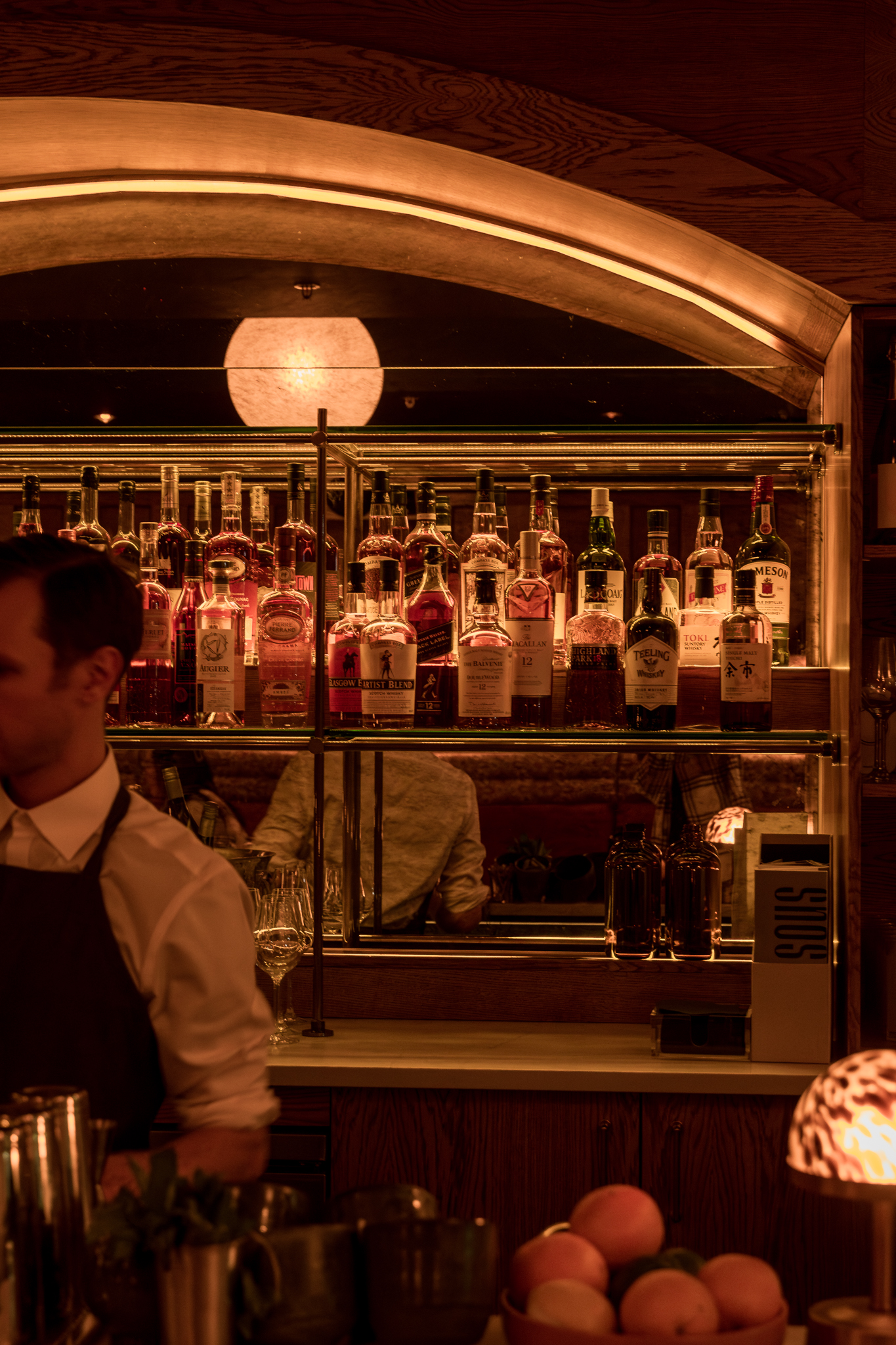 Dim romantic cocktail bar with warm lights, similar in mood to Bisous in Chicago's Fulton Market