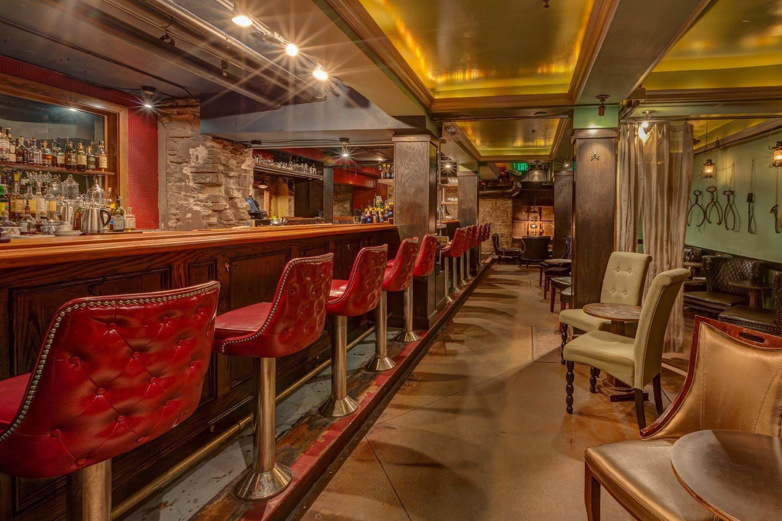 Intimate seating area in The Green Russell speakeasy basement bar