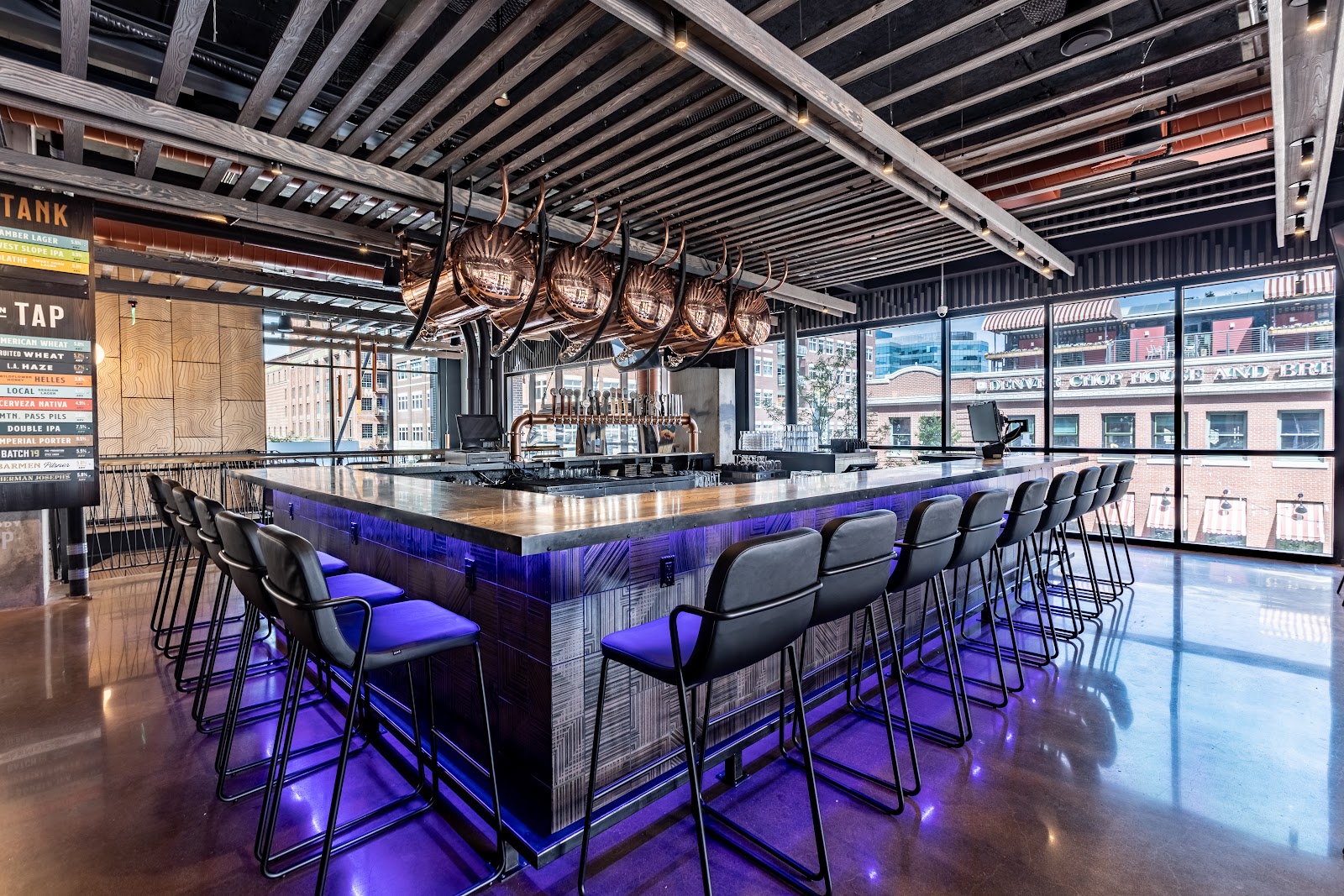 Big modern bar room with screens and crowds, similar in feel to Tom's Watch Bar Denver