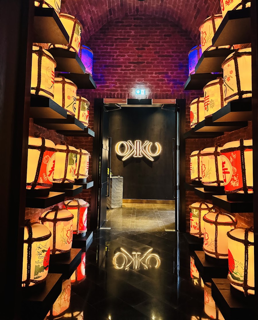 Okku sake selection on a backlit shelf