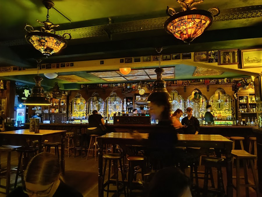 Bar stools along a worn wooden counter