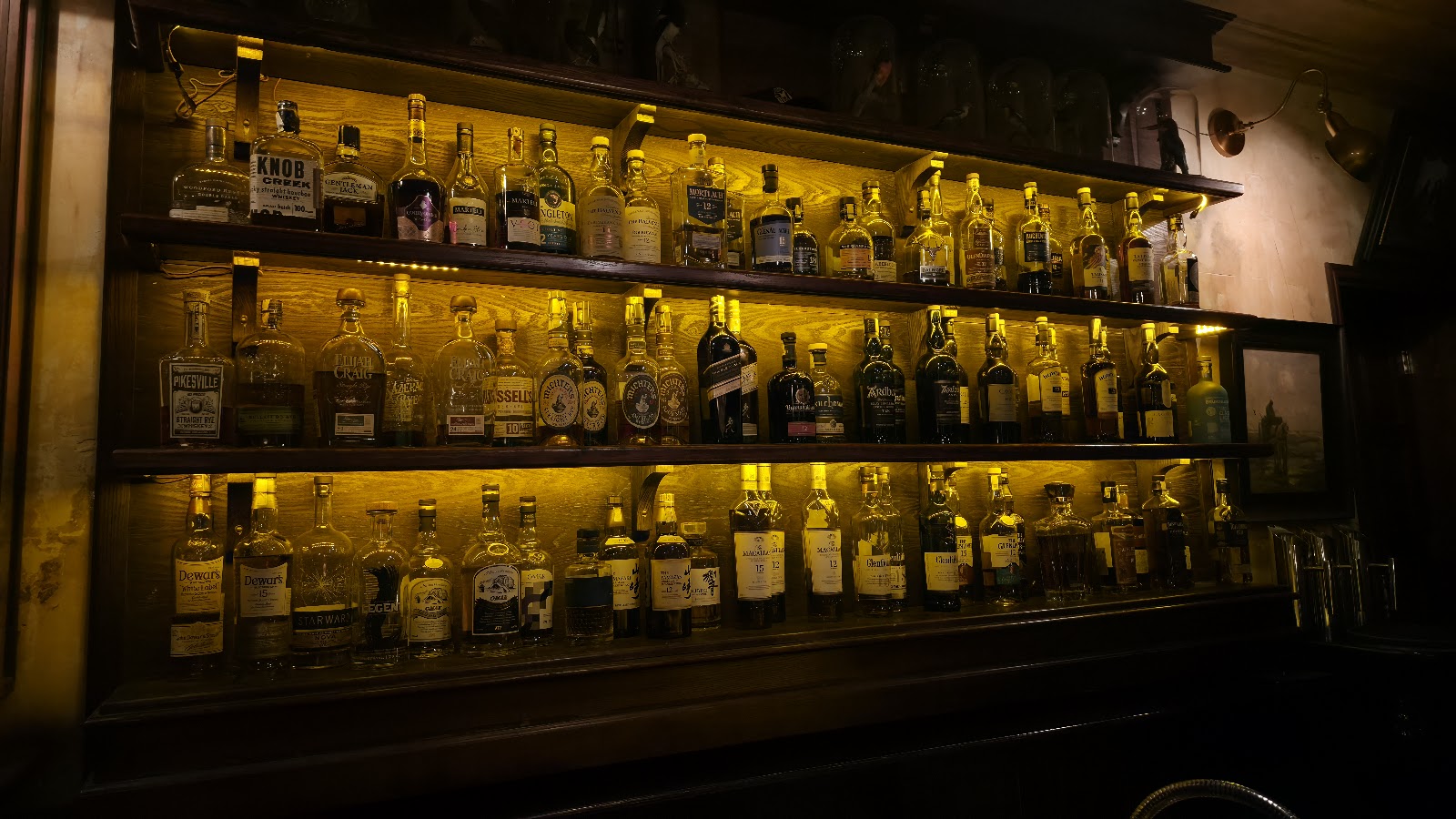 Dim speakeasy bar interior, similar in mood to The Haflington in Hanoi
