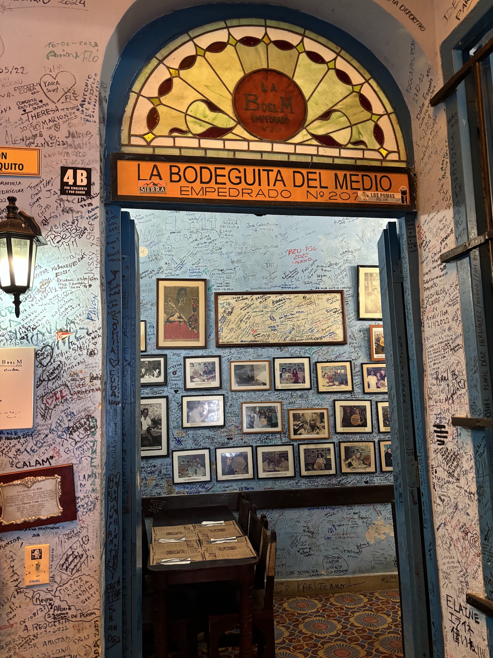 Dark wooden bar interior with bottles, similar in mood to La Bodeguita del Medio in Havana