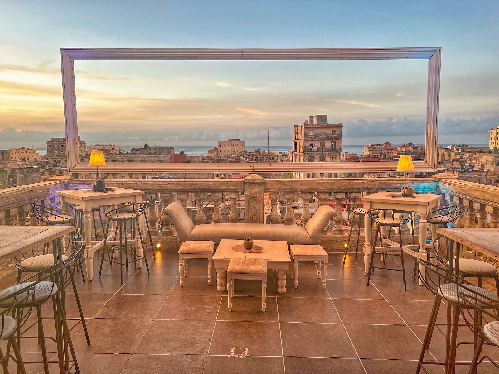 Cocktail on a rooftop bar ledge at golden hour