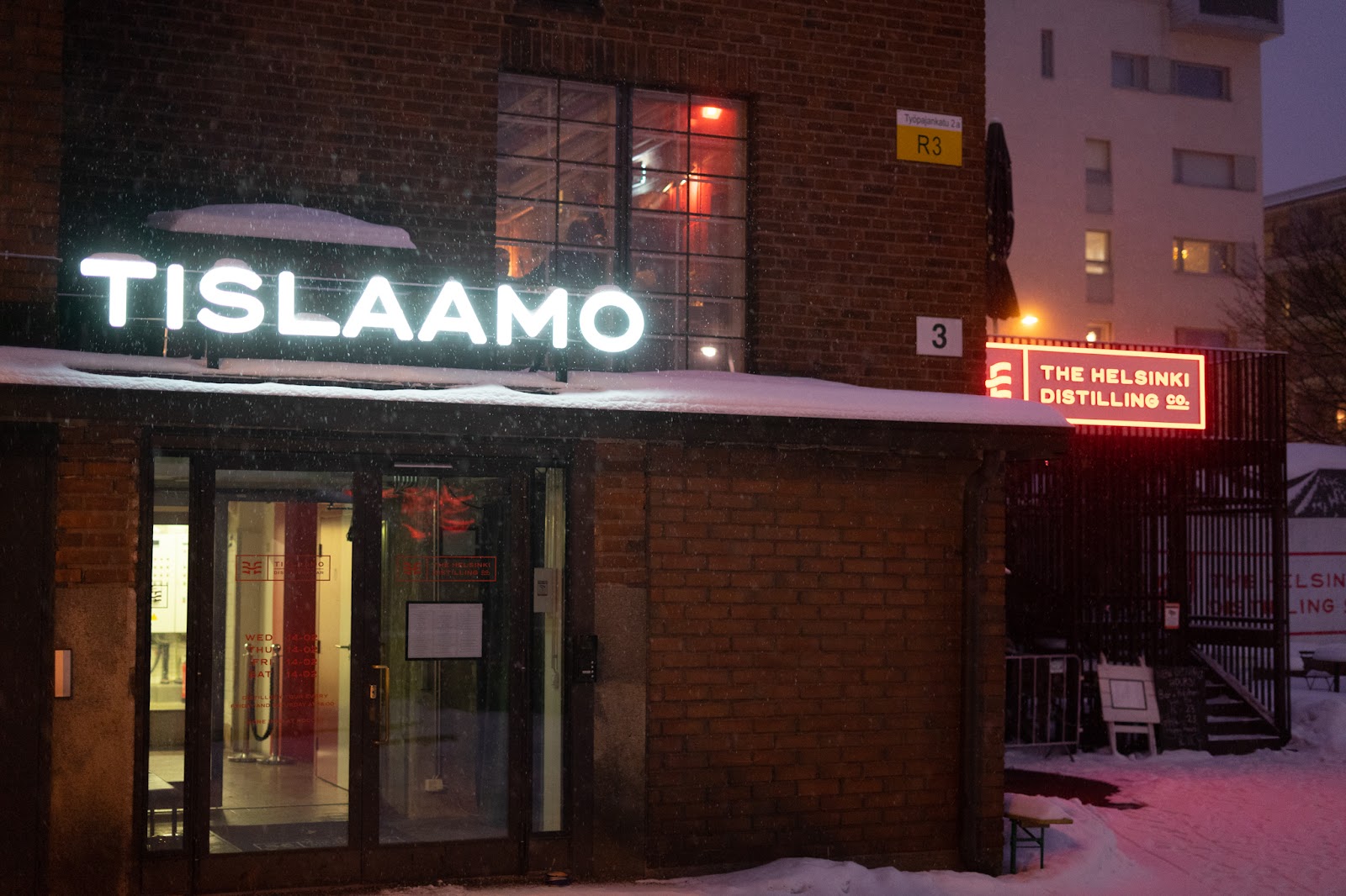 Back bar bottles in warm low light, similar in mood to Tislaamo Distillery Bar in Helsinki