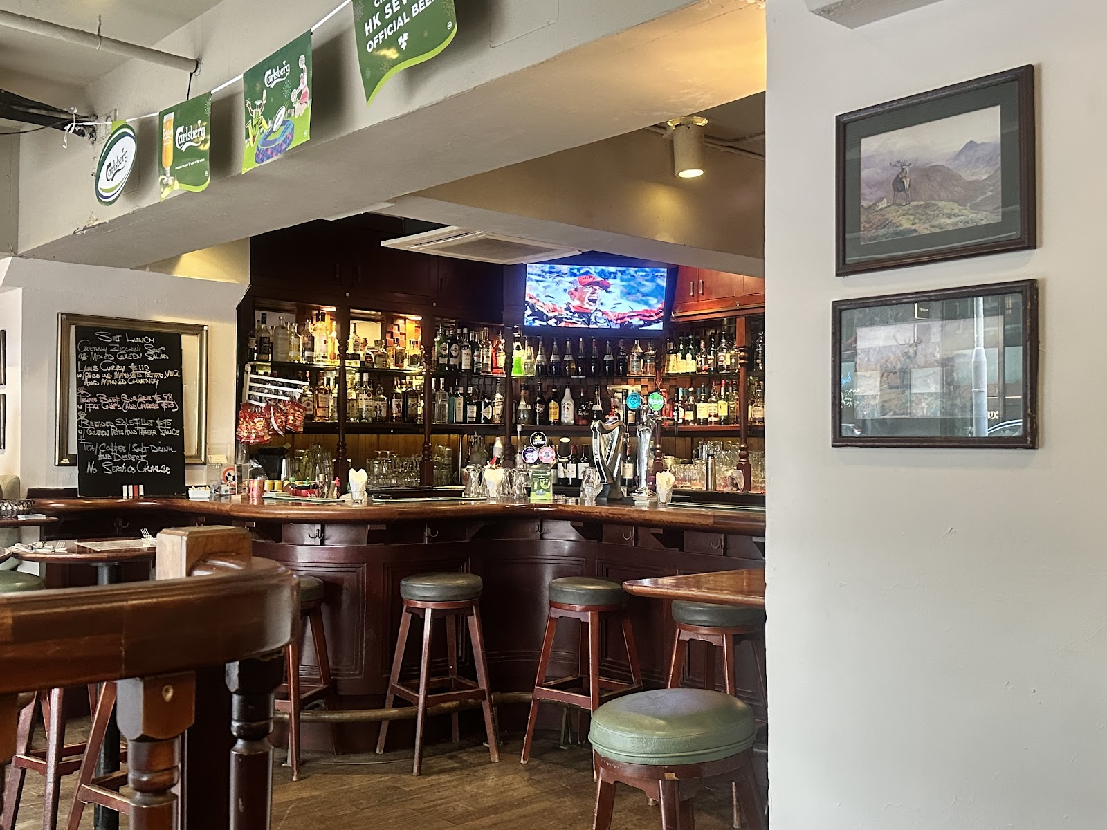 Open fronted British pub interior with wooden bar