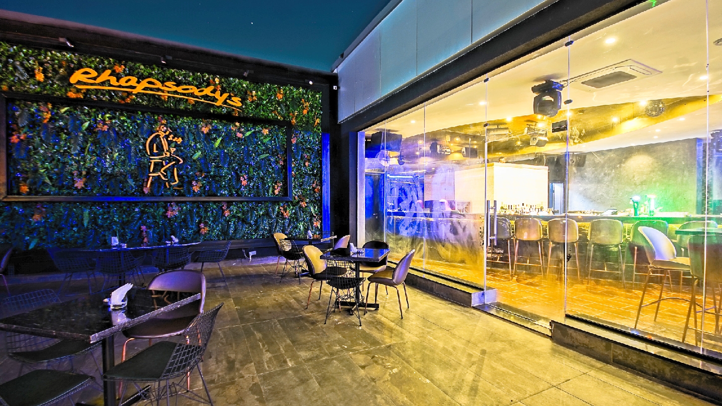 Rooftop lounge bar in the evening, similar in mood to Rhapsody's in Ikeja GRA, Lagos