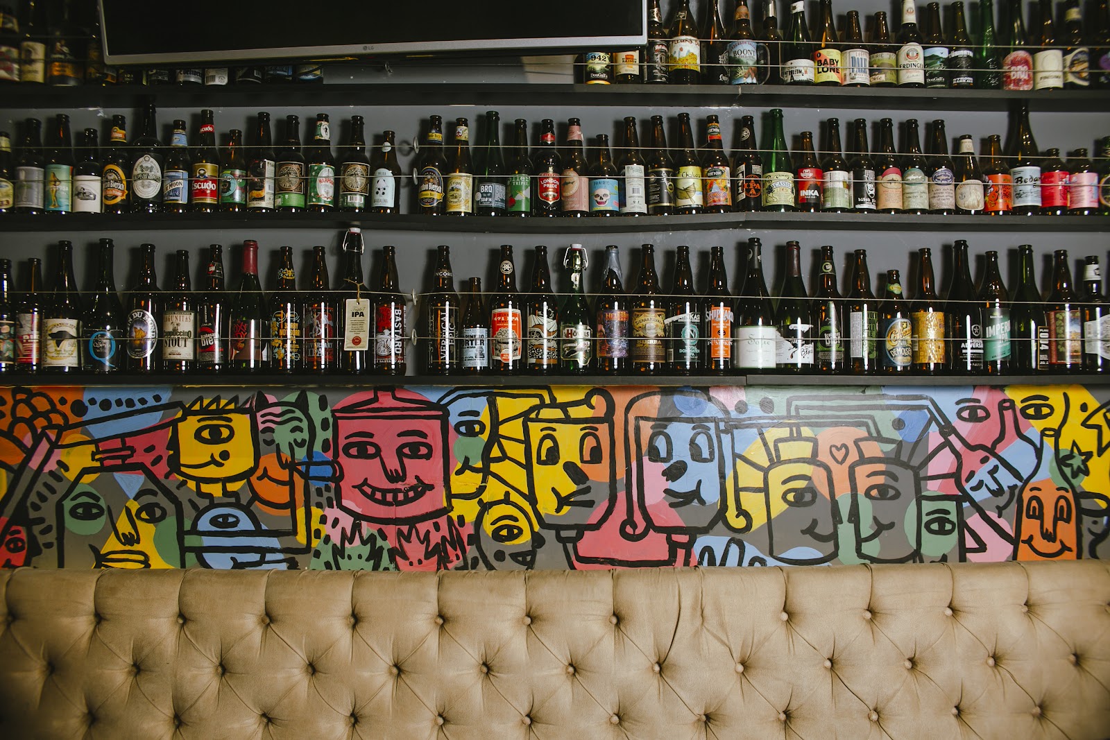 Craft beer taps and full glasses on a bar, similar in feel to BarBarian Miraflores Lima