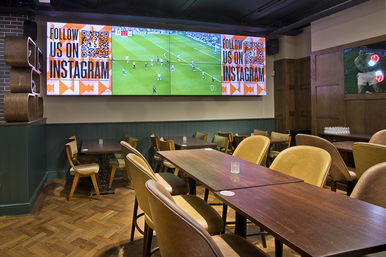Interior of The Three Lanterns sports bar with large screens near Leicester Square, London