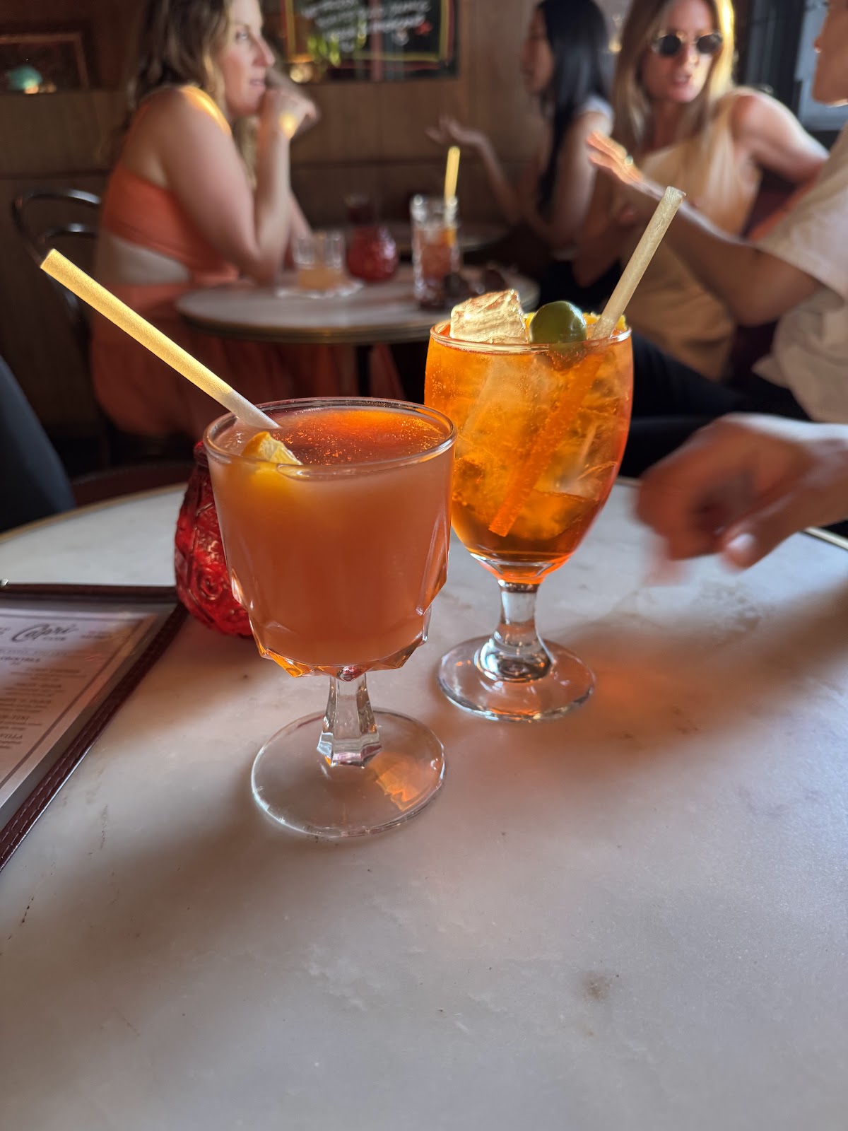 Bar stools at a warm vintage counter, similar in mood to Capri Club in Eagle Rock, Los Angeles