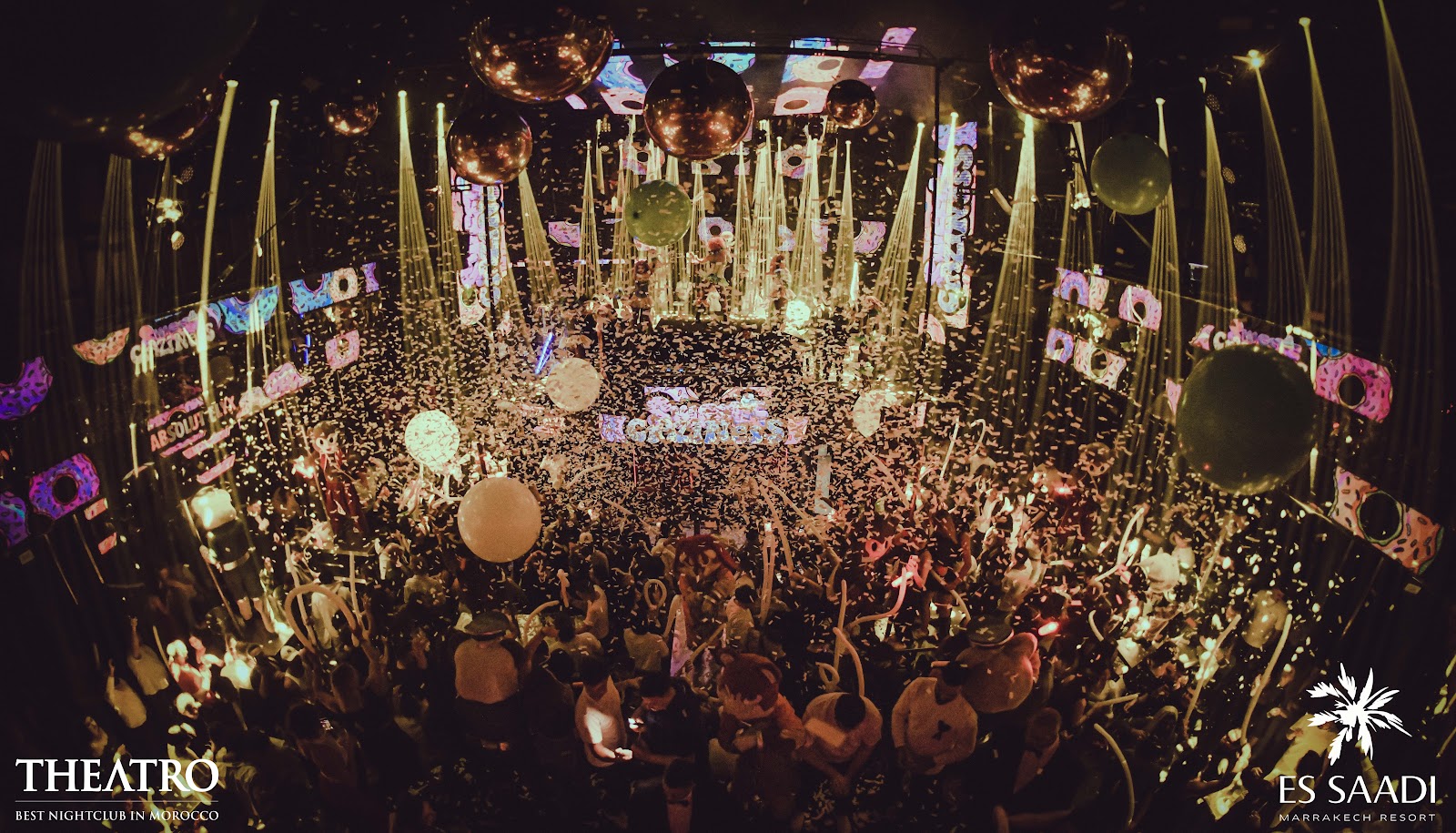 Dark nightclub bar interior with dramatic stage lighting, similar in mood to Theatro Marrakech