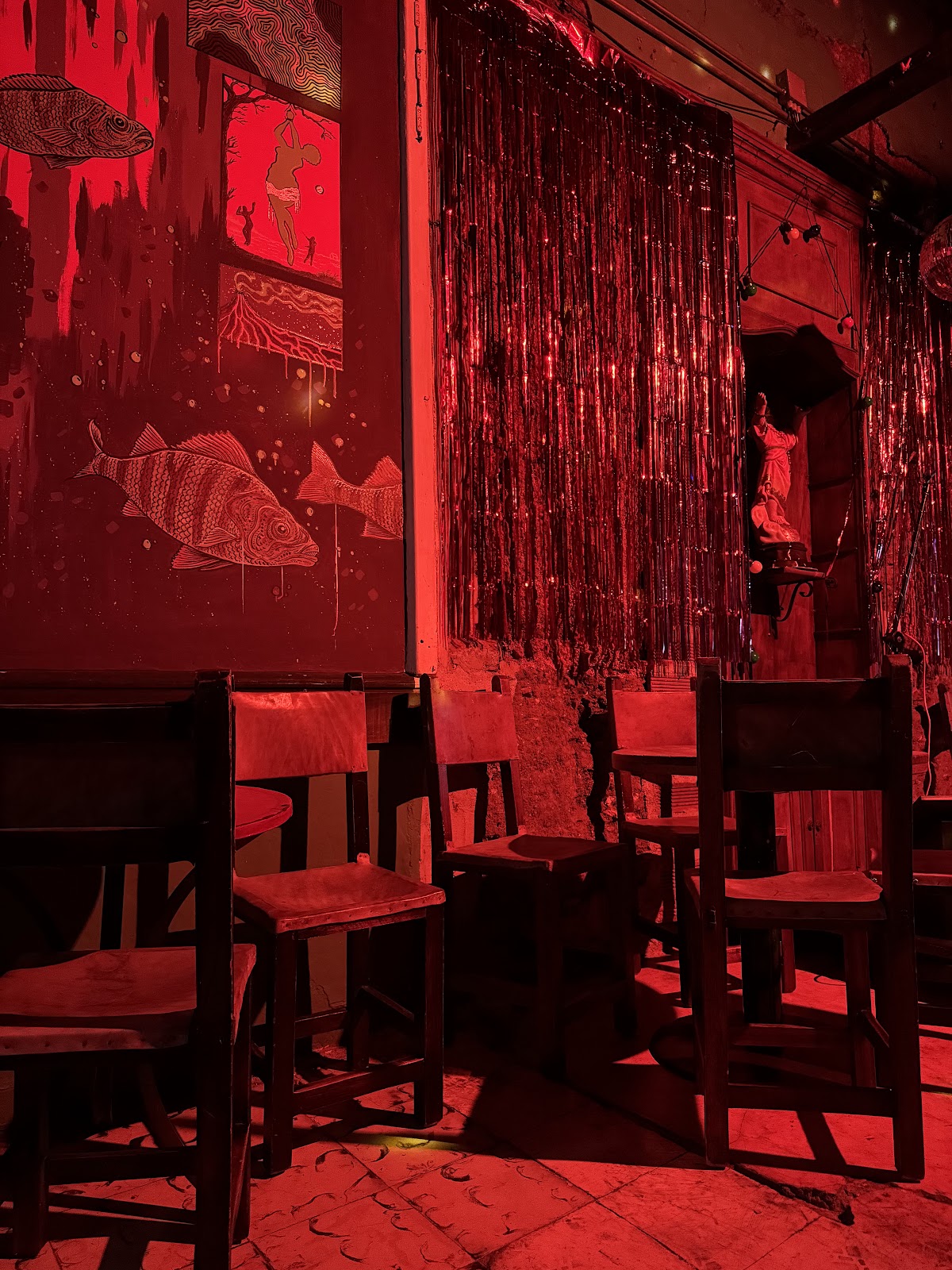 Dim bar interior with bottles behind the counter