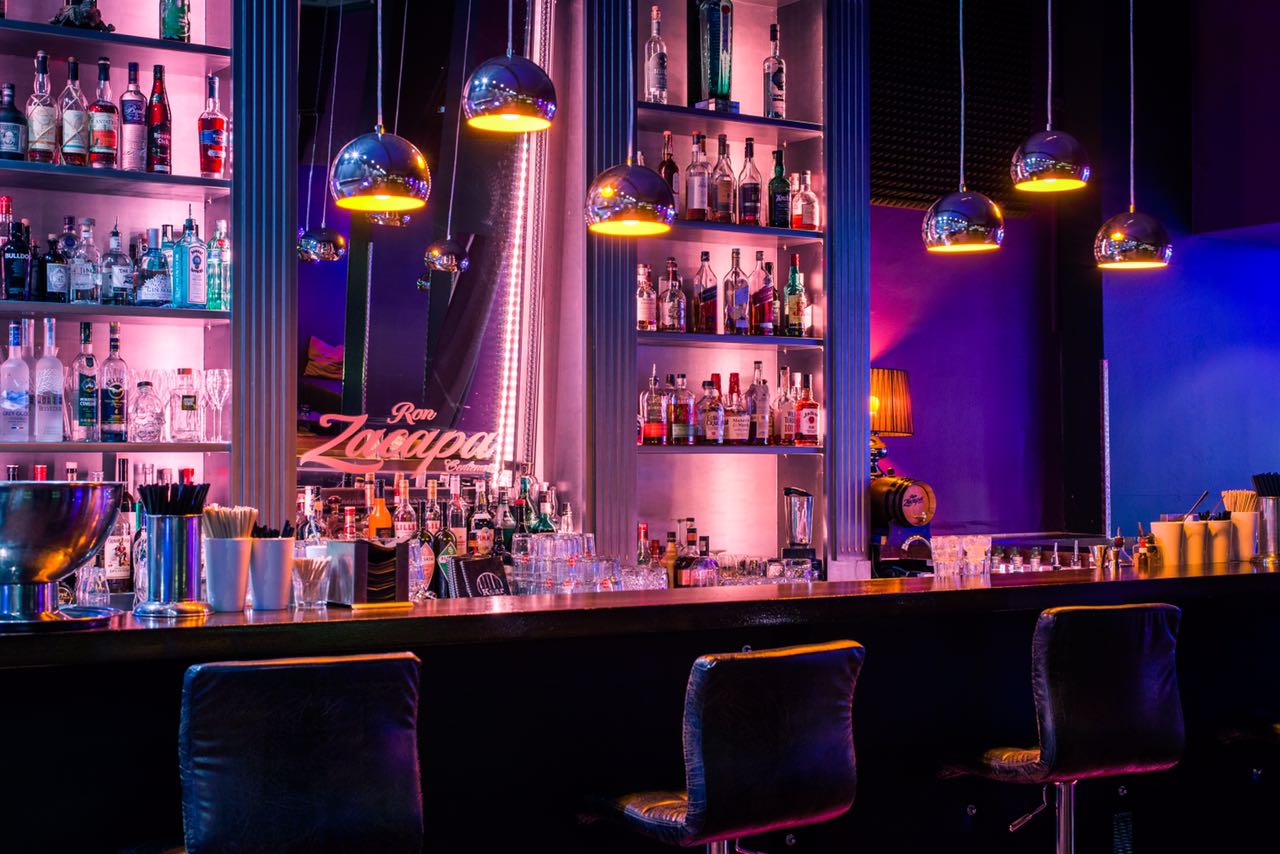 Cocktail barclub lit by pink neon in Munich's Glockenbach quarter