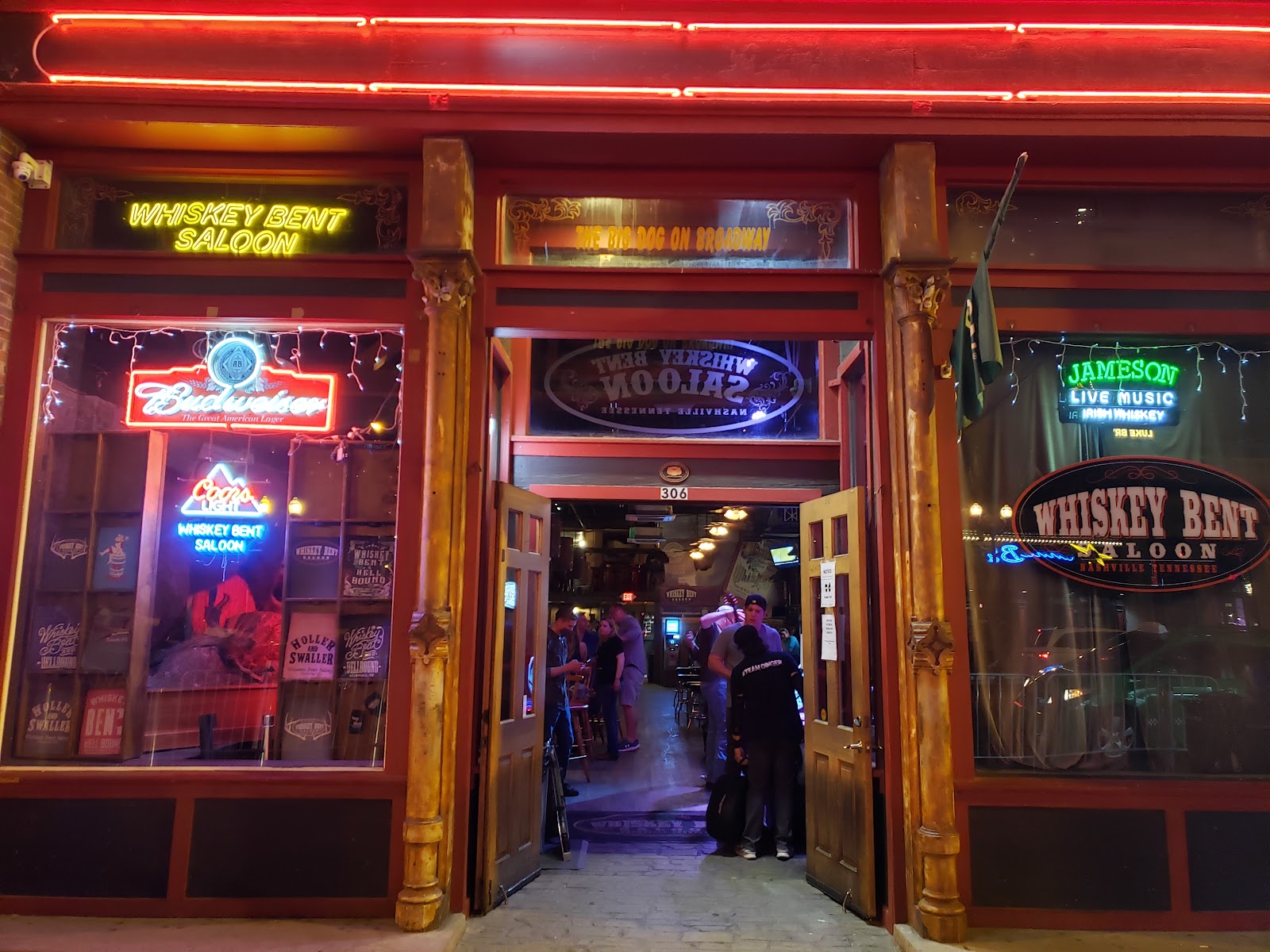 Narrow rustic Broadway saloon with a small stage and live band in Nashville