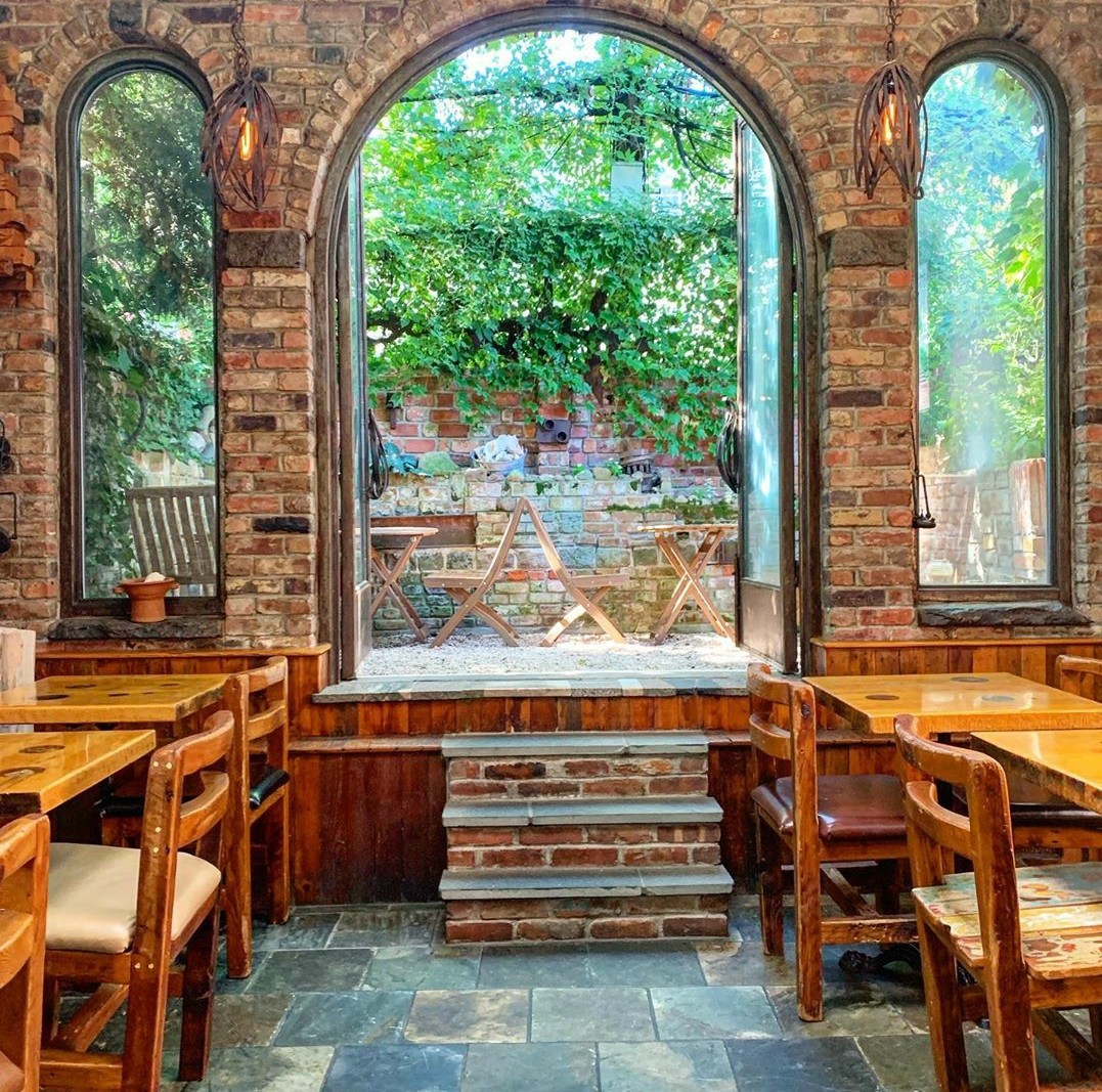 Palo Santo brownstone dining room with exposed brick, Park Slope Brooklyn