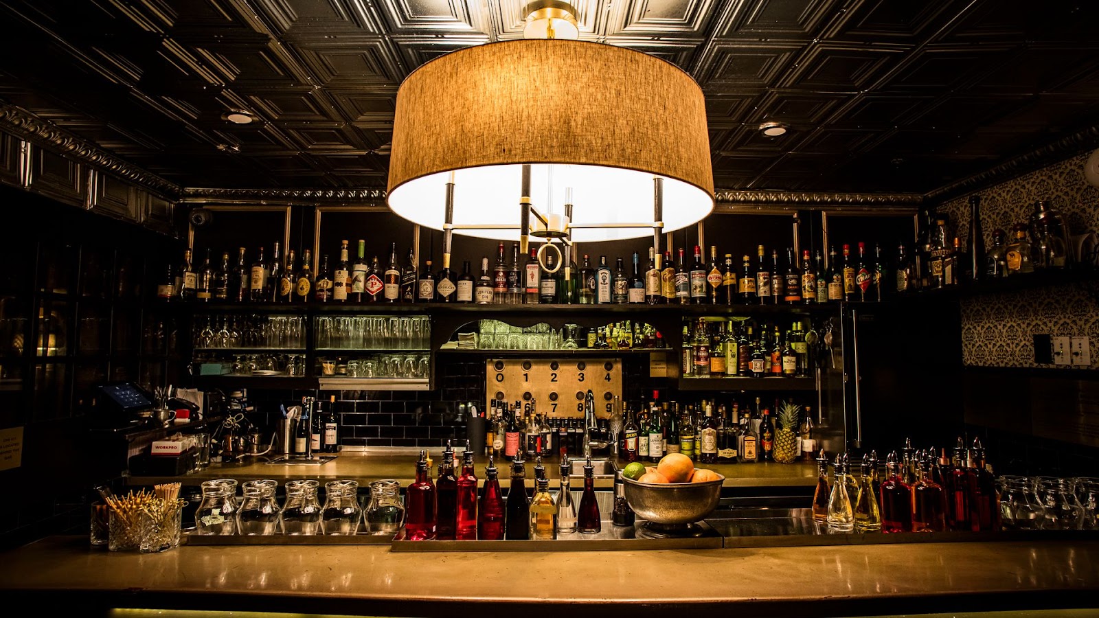 Raines Law Room speakeasy lounge with armchairs and low light, Chelsea New York