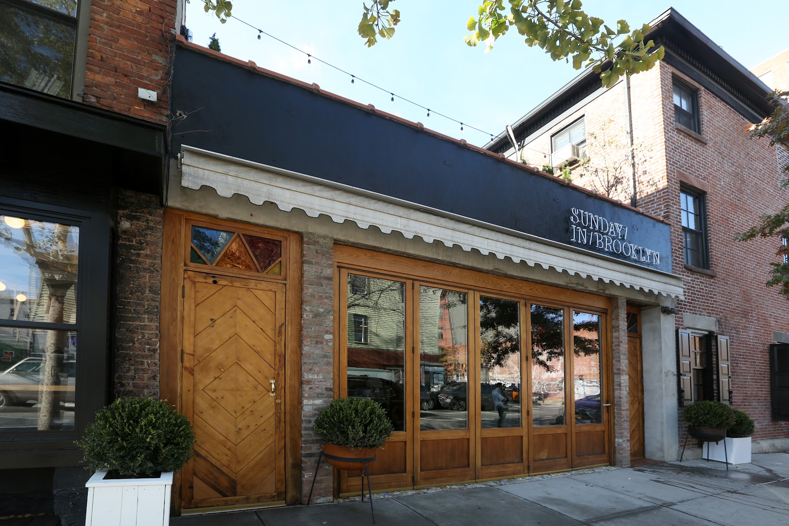 Warm timber dining room and bar with exposed beams, Williamsburg Brooklyn