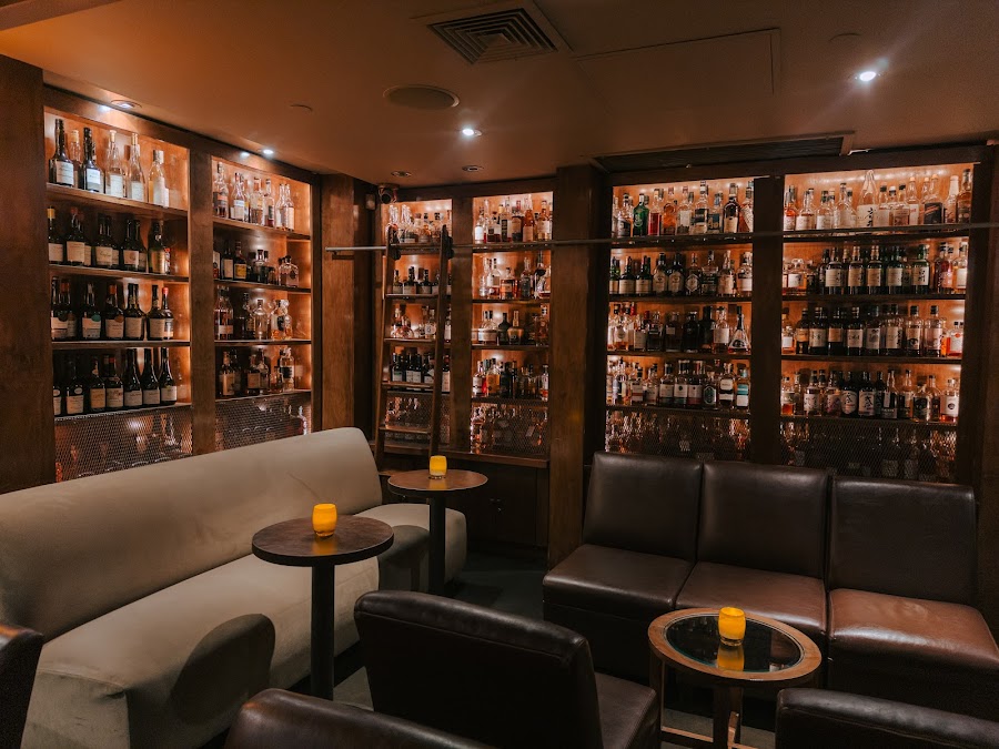 Brandy Library floor-to-ceiling spirit shelves and reading lamps, Tribeca New York