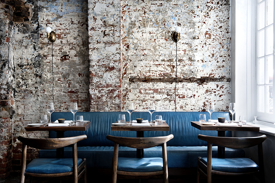 Low-lit dining room and long walnut bar at The Musket Room, Nolita New York