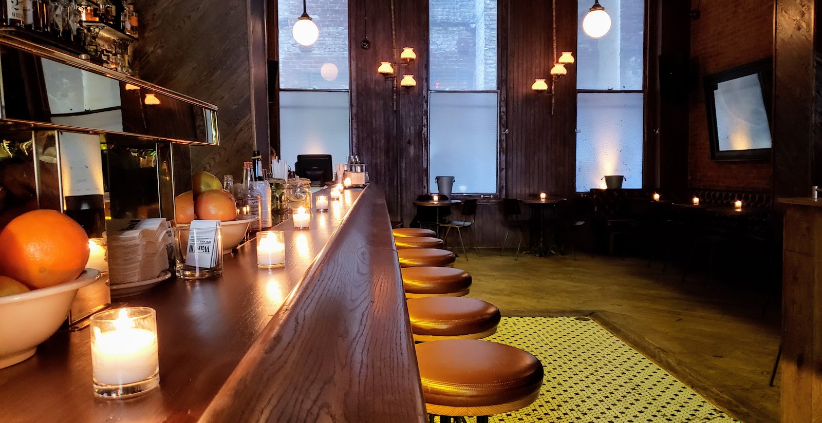 Backlit whiskey shelf and bar at Ward III, Tribeca New York