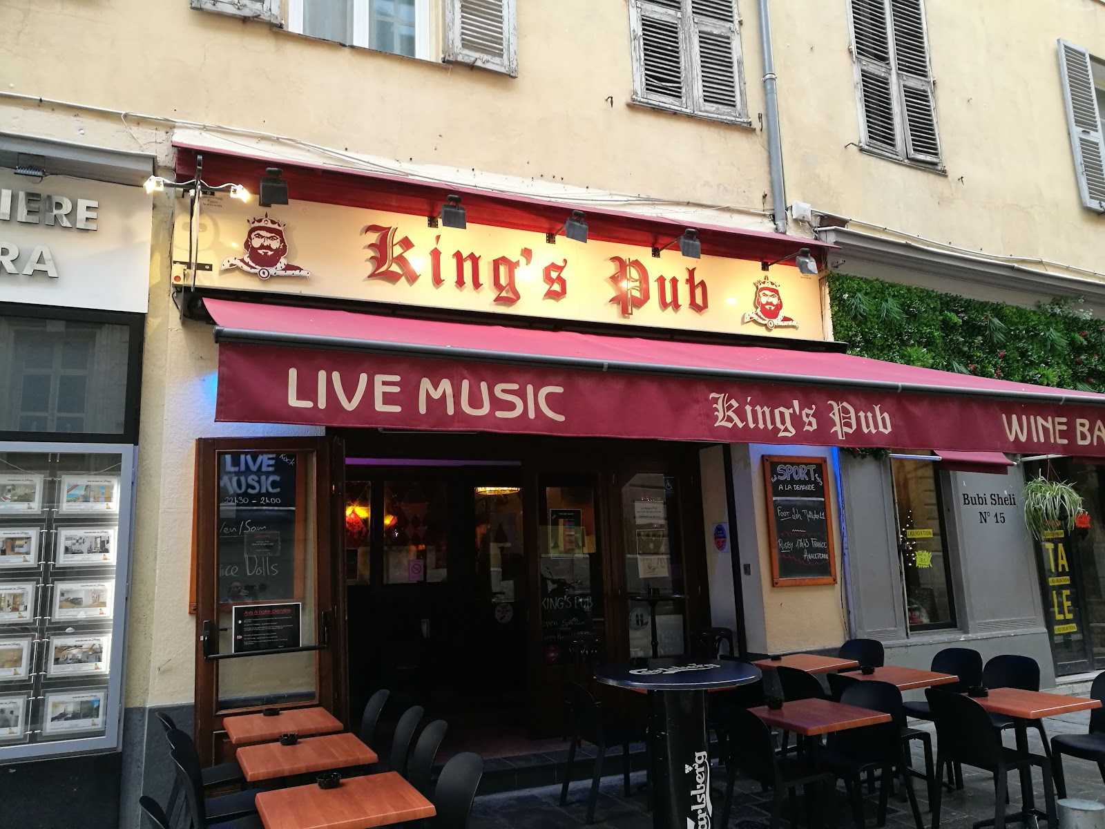 Dark wooden pub interior with stage lighting in Nice old town