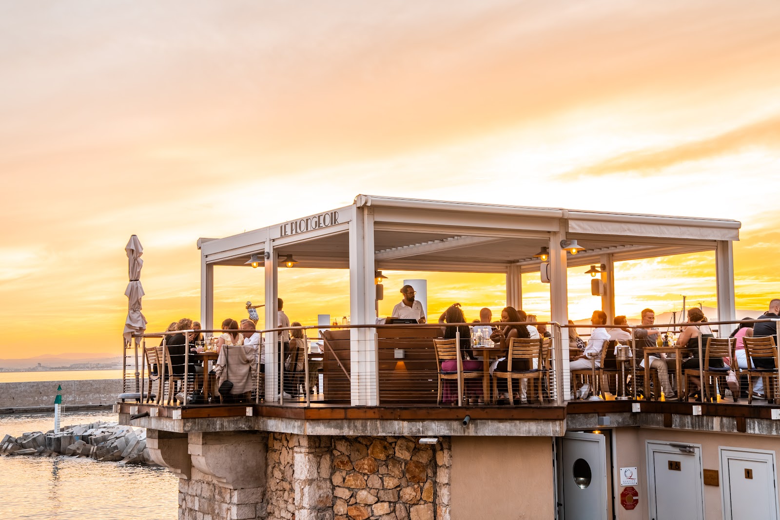 Sunset drinks on a terrace above the sea near Nice