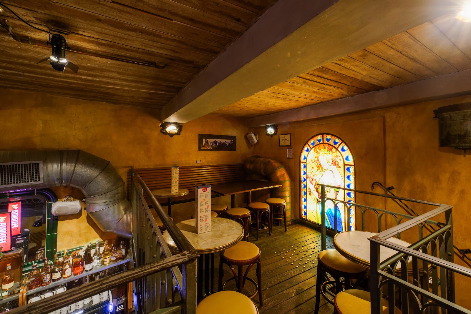 Brass taps and wooden counter of a historic Nice bar