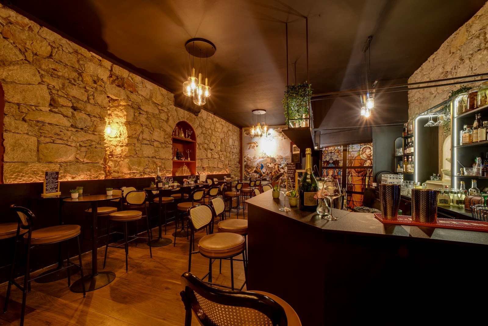 Cocktail on a dark bar counter in a stone walled Nice bar