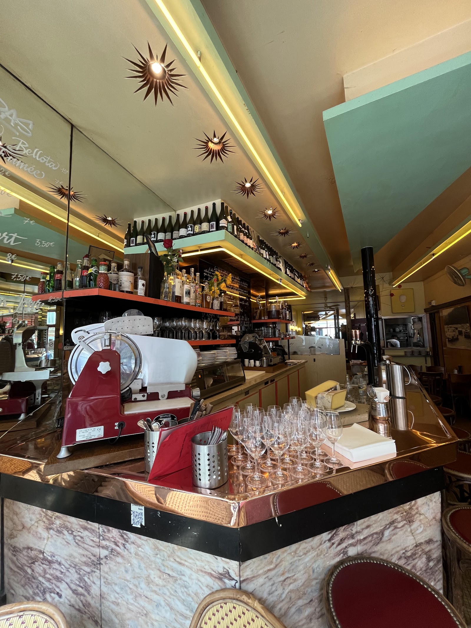 Vintage Paris wine bar with a zinc bar and mirrored walls on Rue Oberkampf
