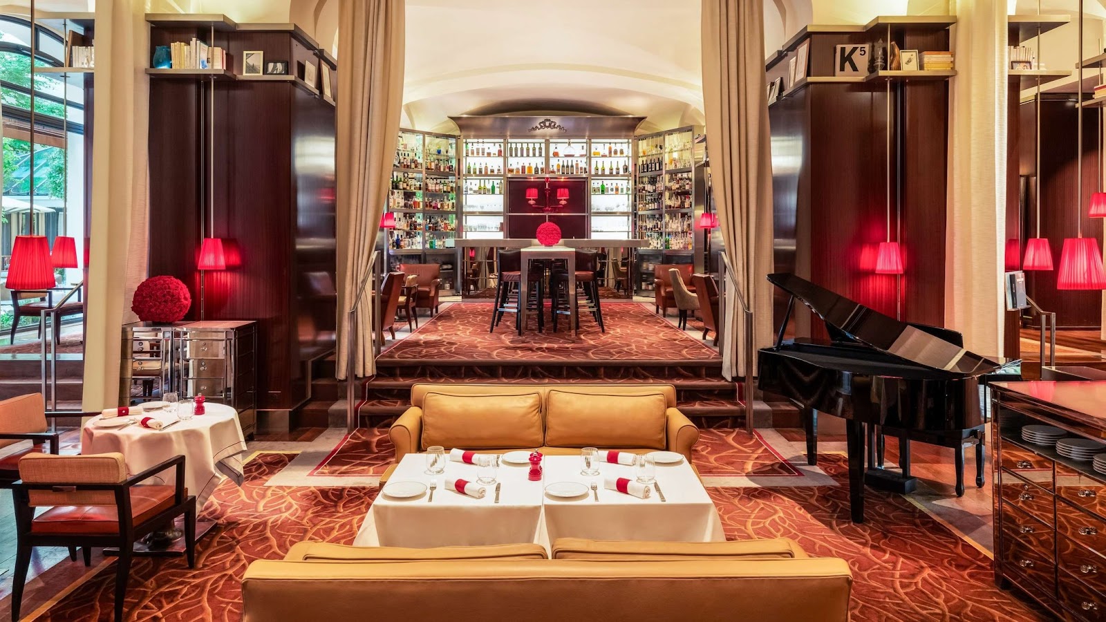 Elegant low-lit palace hotel bar with a long illuminated counter