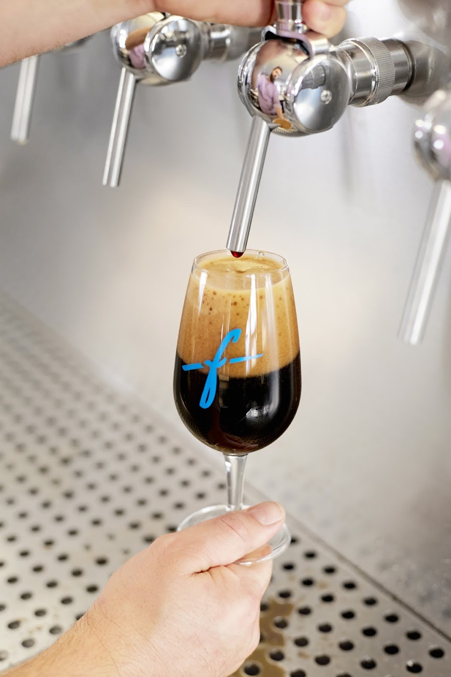 A flight of craft beers on a taproom bar