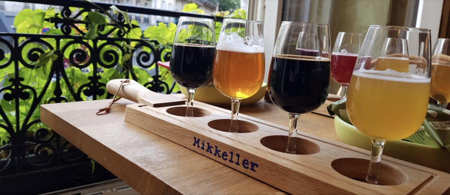 Glasses of craft beer lined up on a bar