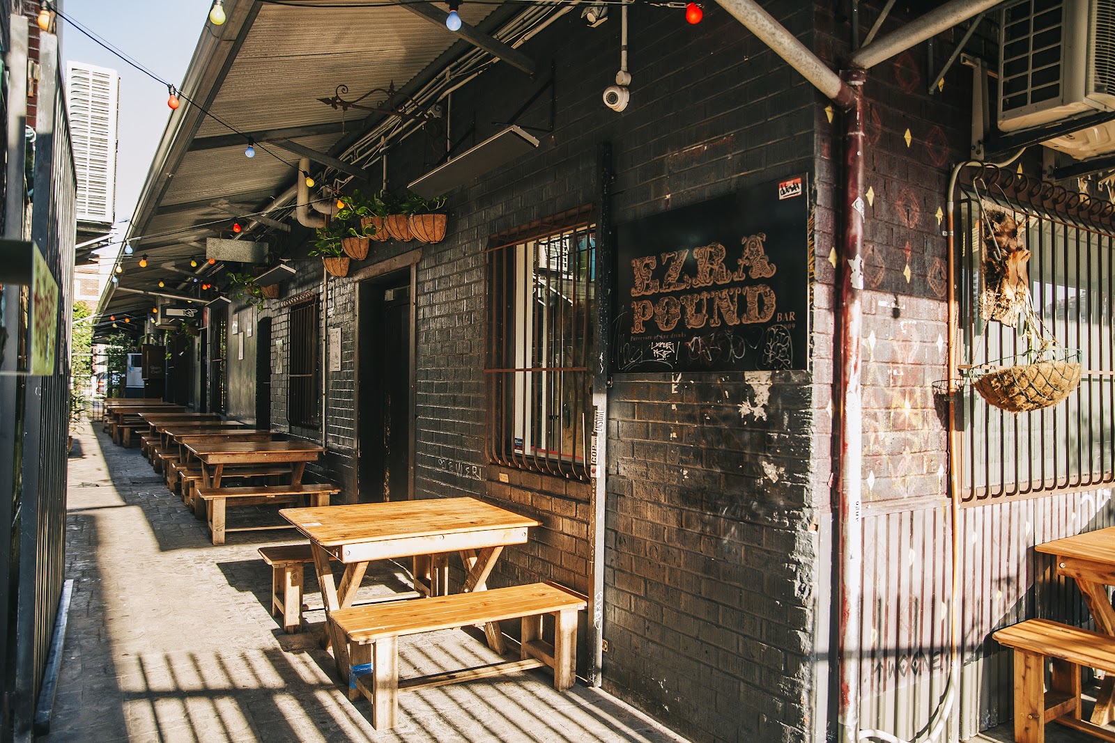 Dim laneway bar interior with mismatched vintage furniture