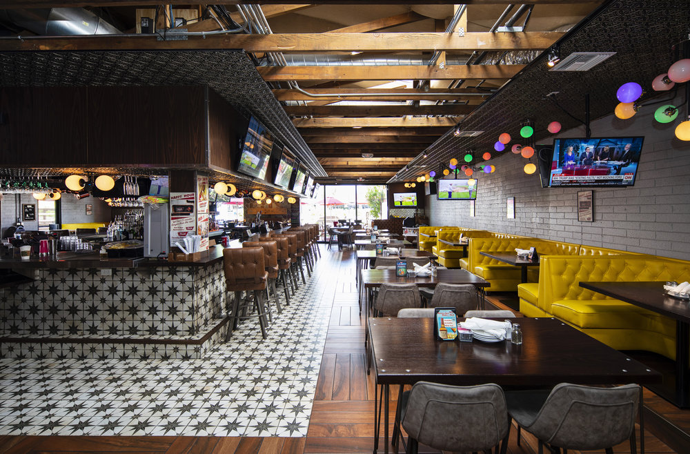 Shaded patio bar with string lights and outdoor seating in Arcadia, Phoenix