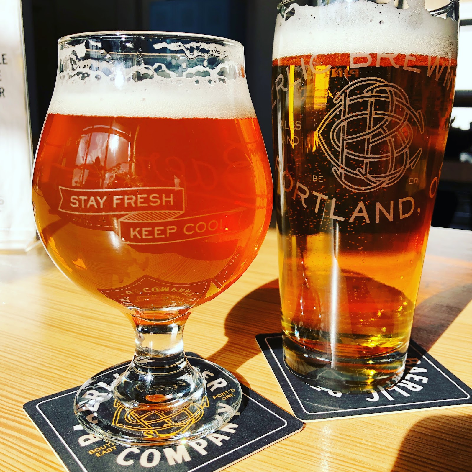 Craft brewery taproom with rows of taps and wood tables in Portland
