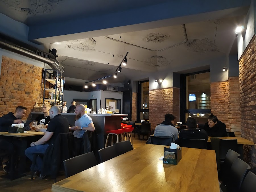 Bank of sports screens above a long bar counter