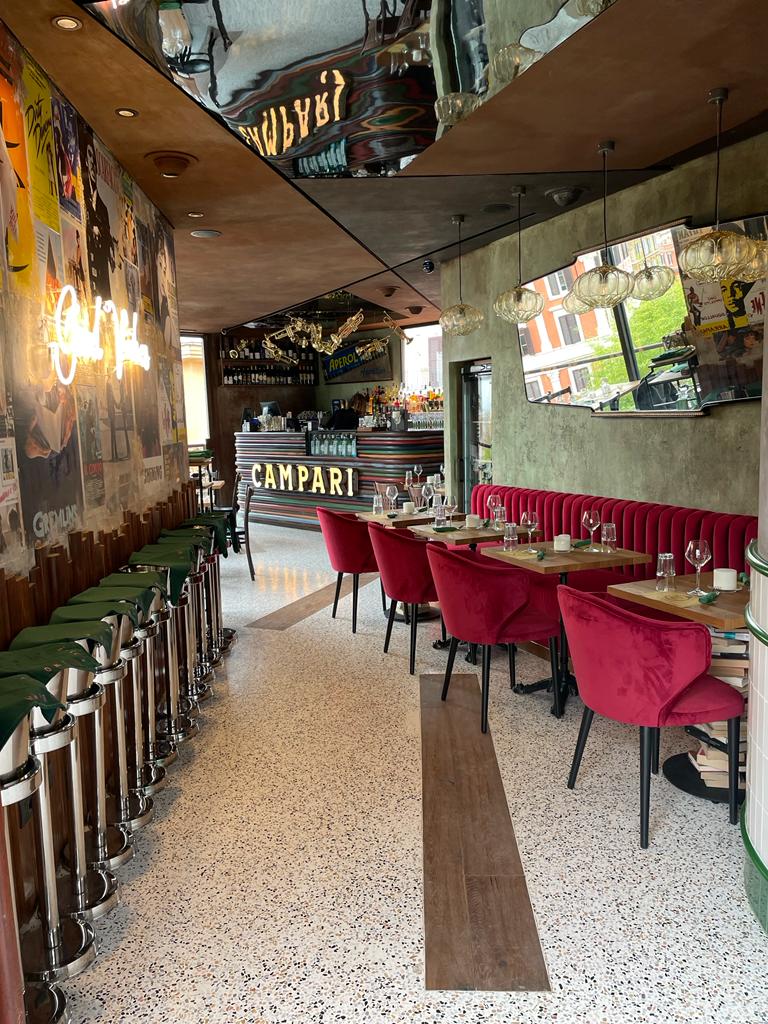 Dim jazz-and-blues bar lined with concert posters in Trastevere, Rome