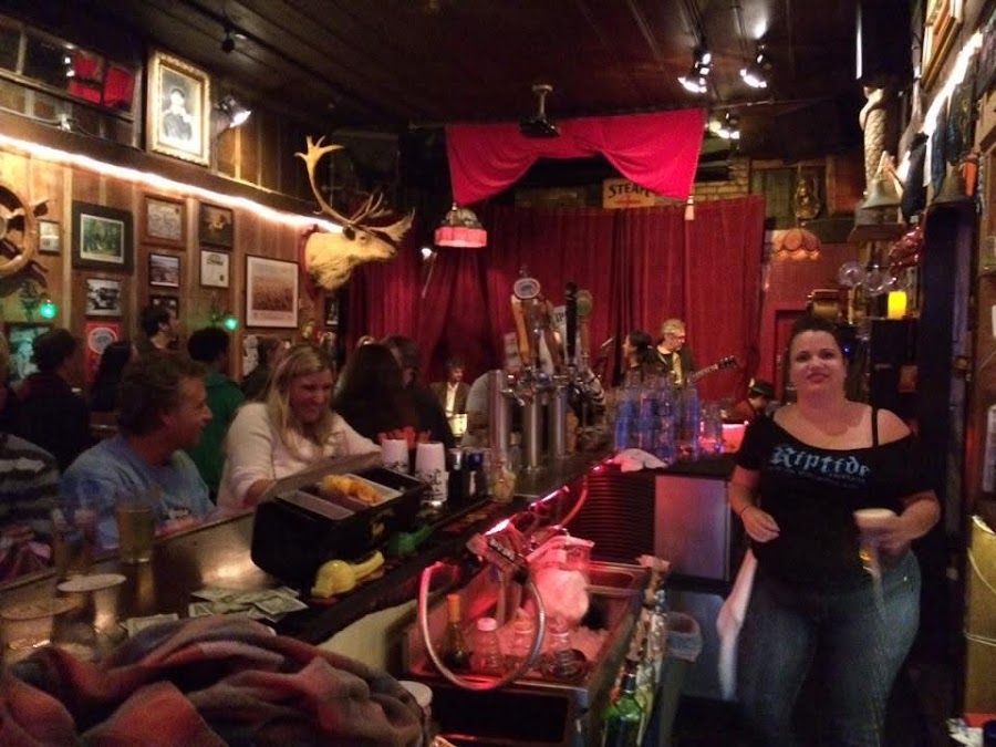 Wood fireplace and worn booths at The Riptide in the Outer Sunset