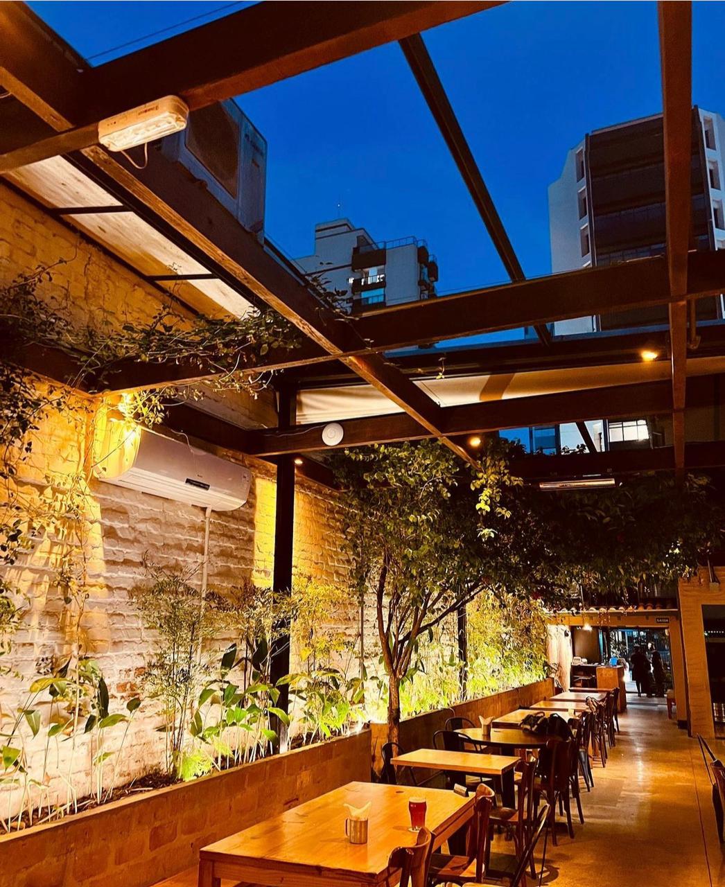 Craft beer taps and barbecue plates in a 1930s house bar in Pinheiros, Sao Paulo