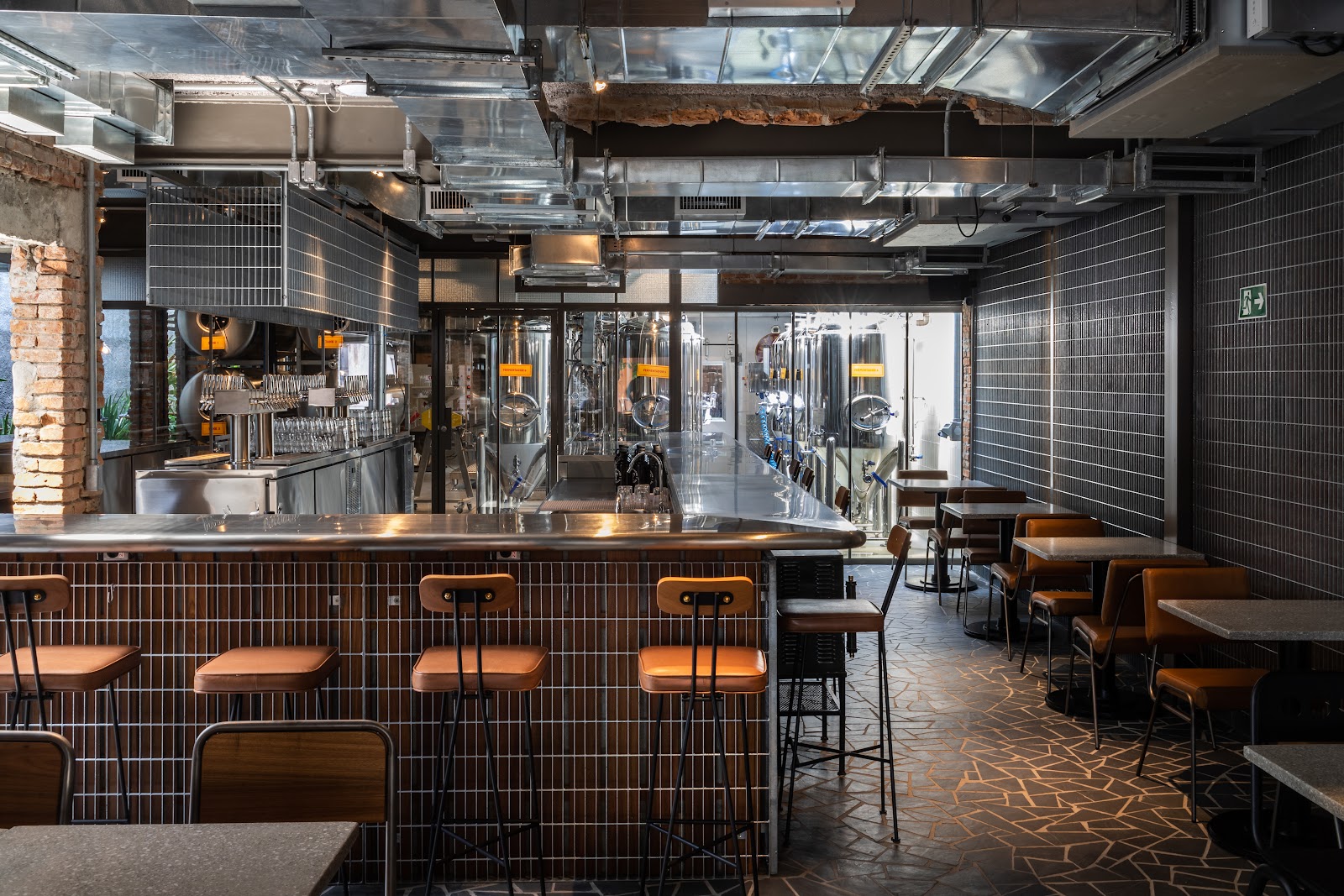 Brewpub interior with tanks and a bar in Sao Paulo