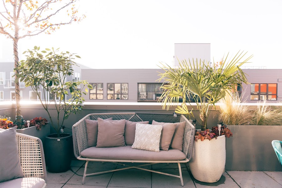 White baby grand piano in a warm-lit rooftop lounge
