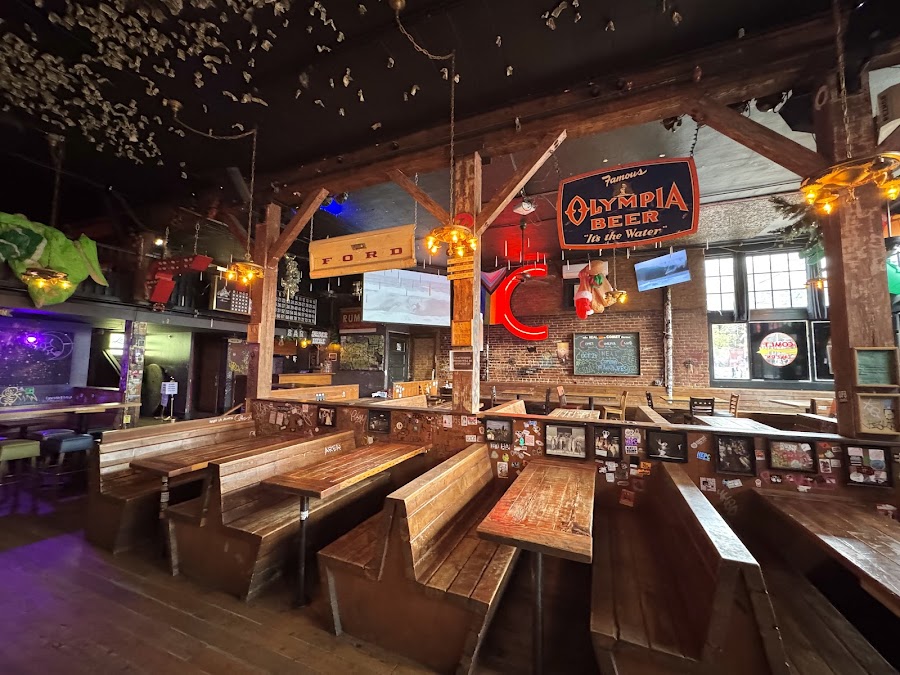 Dim neon-lit dive bar room set for live music