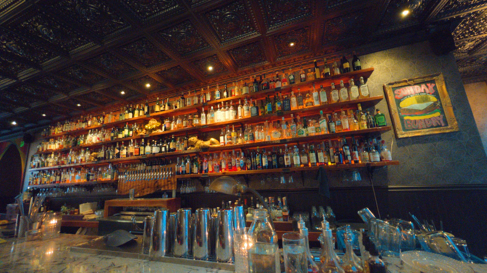 Bottle-lined back bar at Herb and Bitter Public House in Seattle