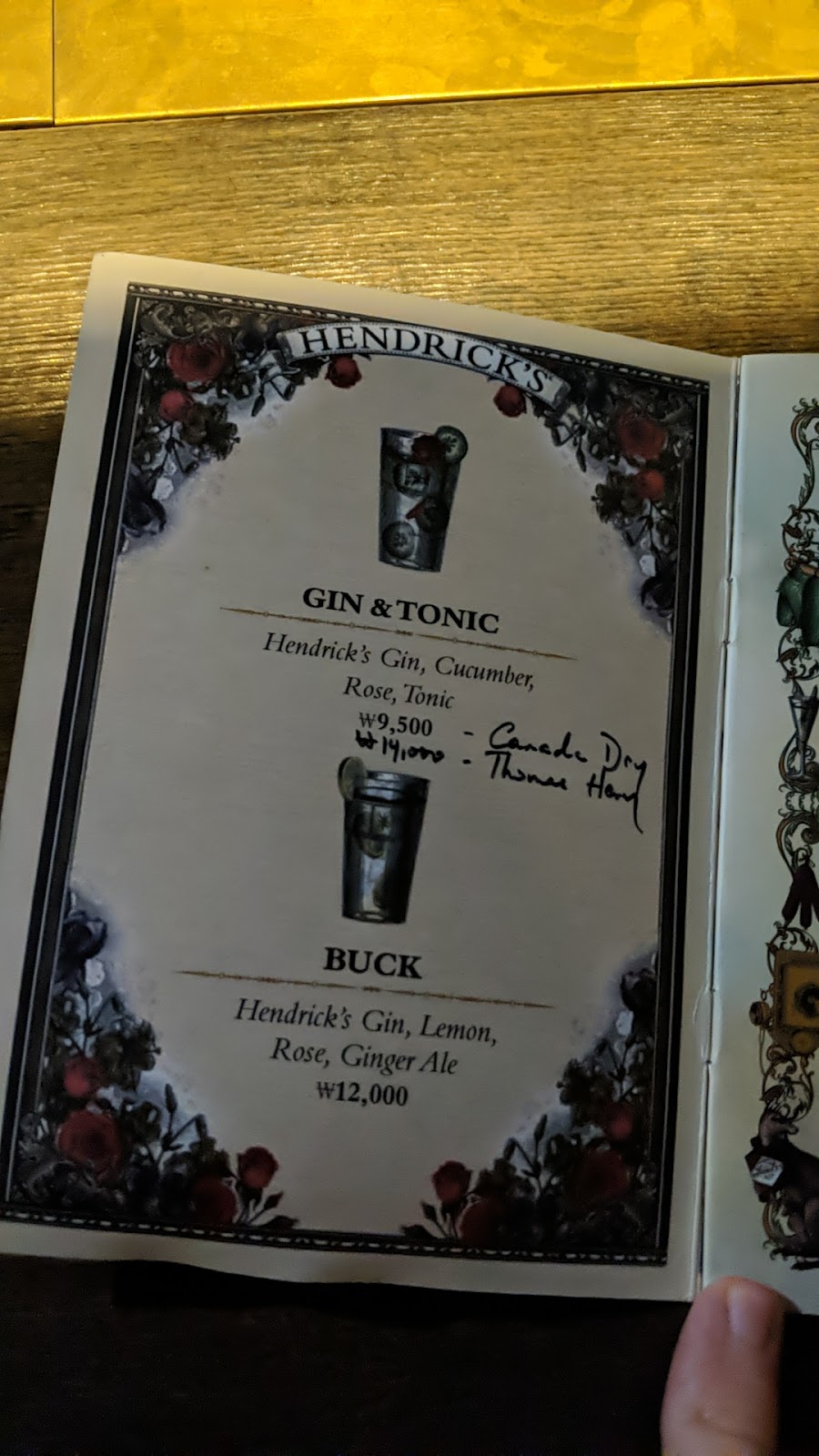 Gin cocktail garnished with flowers on a wooden bar in Seoul