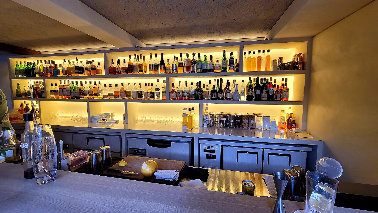 Calm wood and stone cocktail room with a courtyard in a Seoul hanok