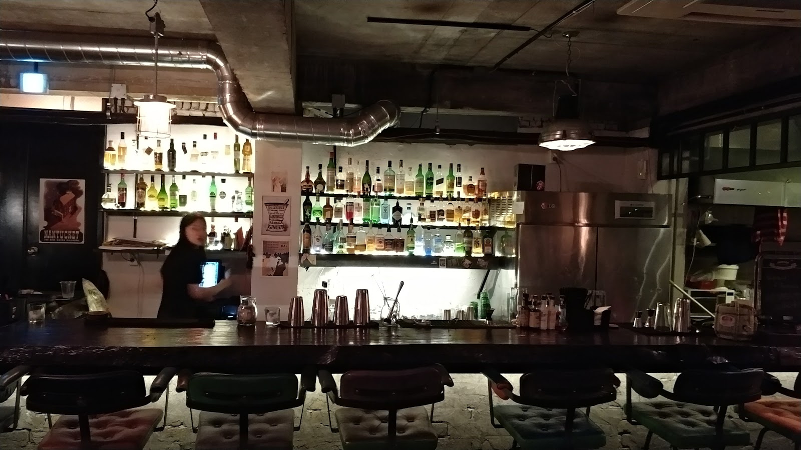 Dimly lit basement speakeasy bar with low seating in Itaewon, Seoul