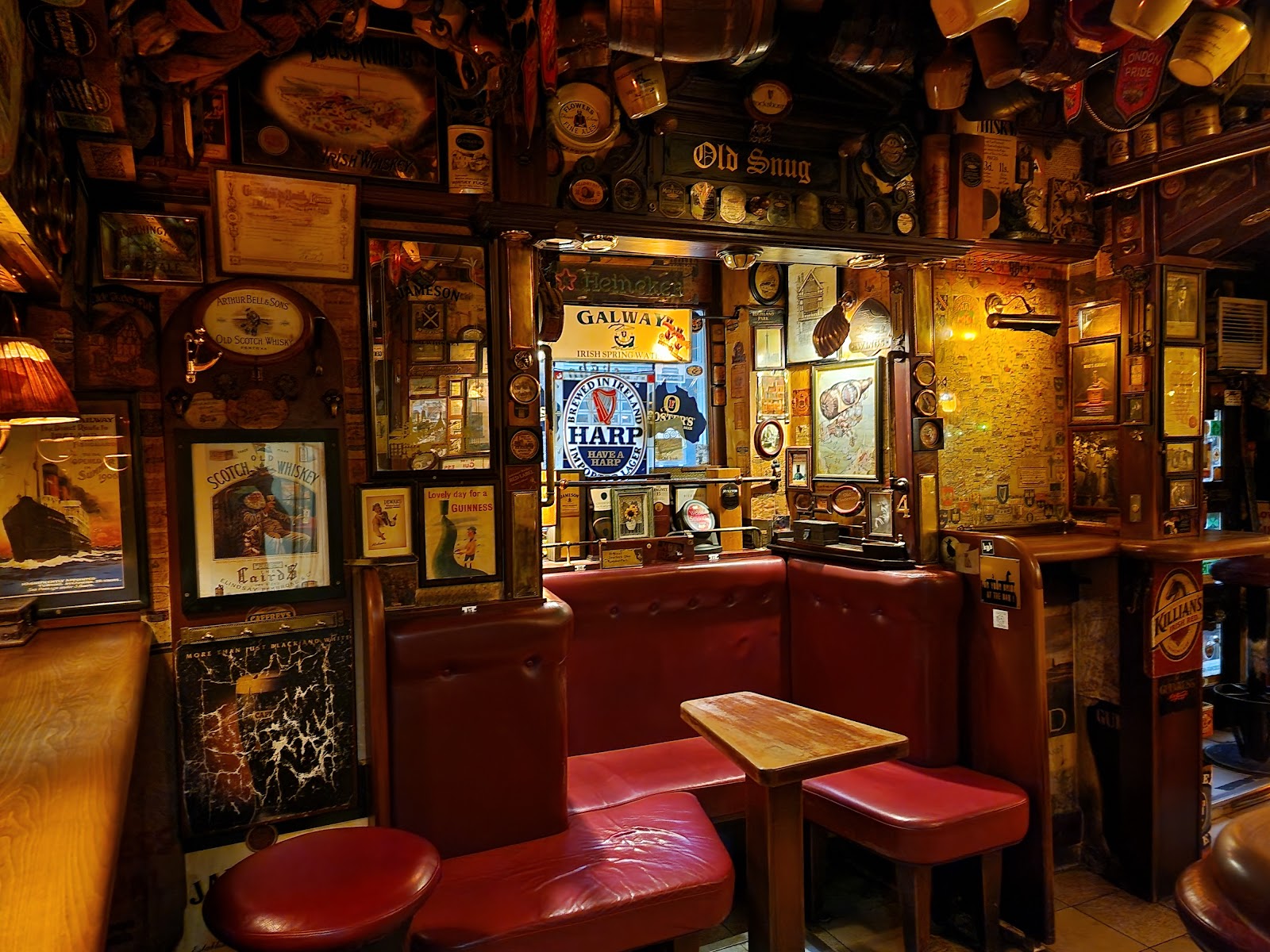 Small old Irish pub interior crowded with posters on Naglergasse Vienna
